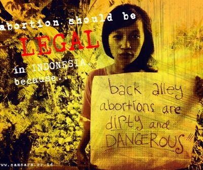 A woman holding up a placard which talking about why abortion should be legal in Indonesia