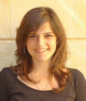 Photo of abortion activist Rola Yasmine. She has shoulder-length brown hair and fair skin. She is wearing a casual shirt.