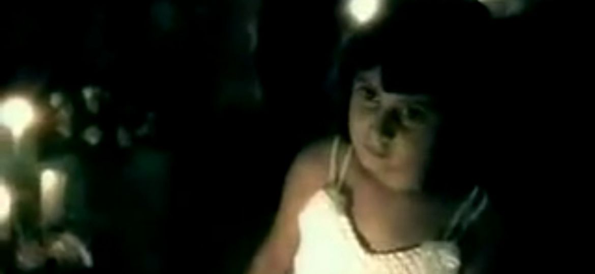 Photo of a young female child in a white dress, saying 'who will melt my chains