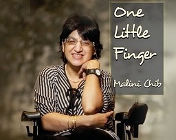 A picture of disability rights activist Malini Chib sitting on a wheelchair. She is has black shoulder-length hair and is wearing glasses. Her top is white with black stripes and her trousers are black. The text beside her reads 'One Little Finger, Malini Chib'