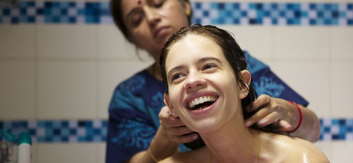 Still from the film 'Margarita with a Straw' showing actress Kalki Koechlin being given a bath by actress Revathy