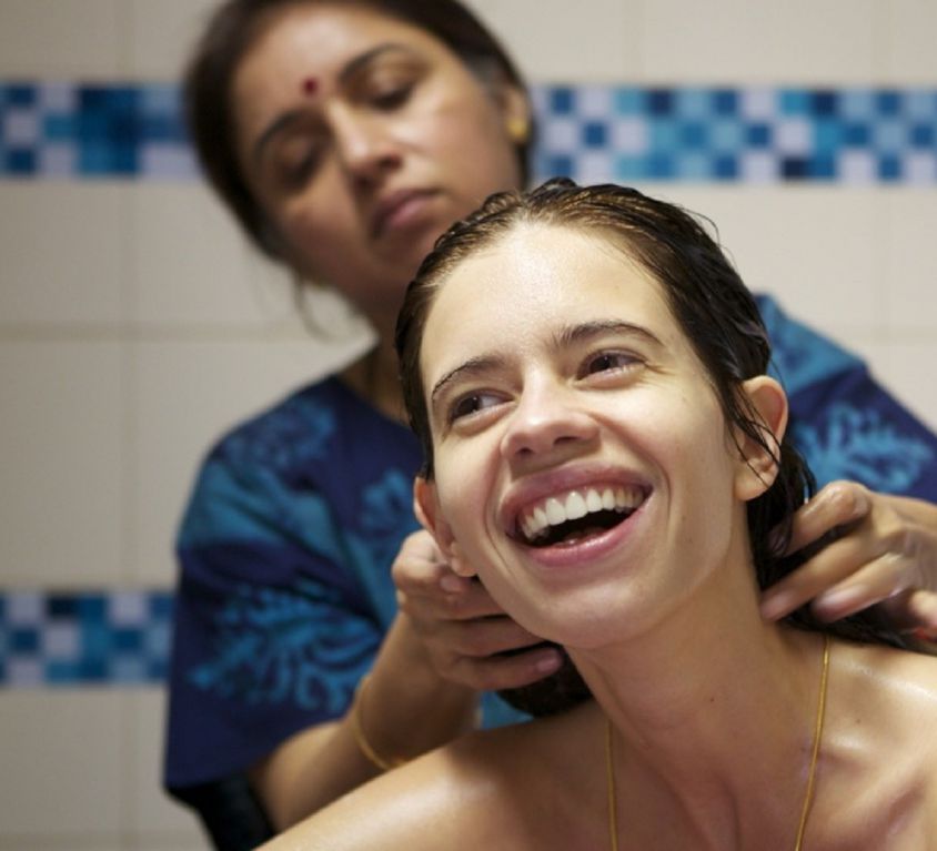 Still from the film 'Margarita with a Straw' showing actress Kalki Koechlin being given a bath by actress Revathy