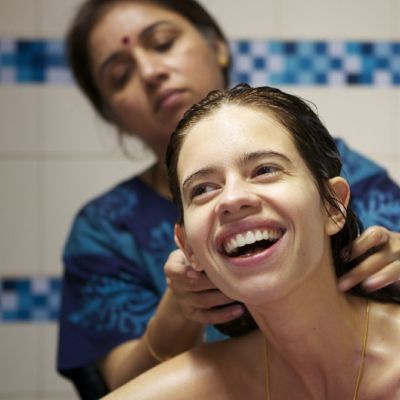 Still from the film 'Margarita with a Straw' showing actress Kalki Koechlin being given a bath by actress Revathy