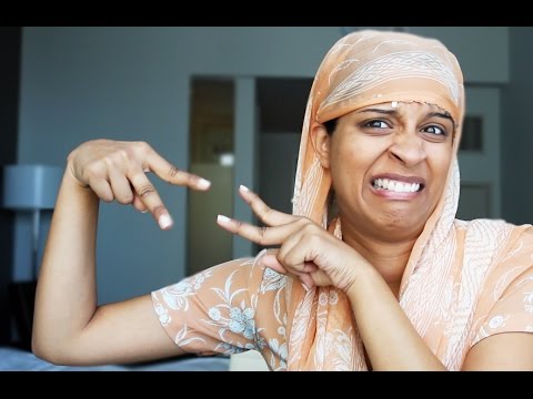 Video still. YouTube star Superwoman has a disgusted expression on her face. She is wearing a light orange Indian suit.