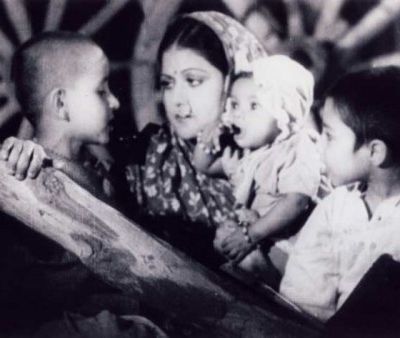 Still from a black and white Indian film, "Aurat" (1940). A mother with her three kids.