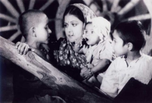 Still from a black and white Indian film, "Aurat" (1940). A mother with her three kids.