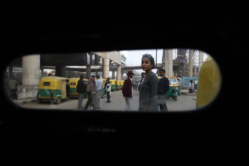 Aanchal, studying fashion media communication, waits for an auto rickshaw outside a metro station in Gurgaon
