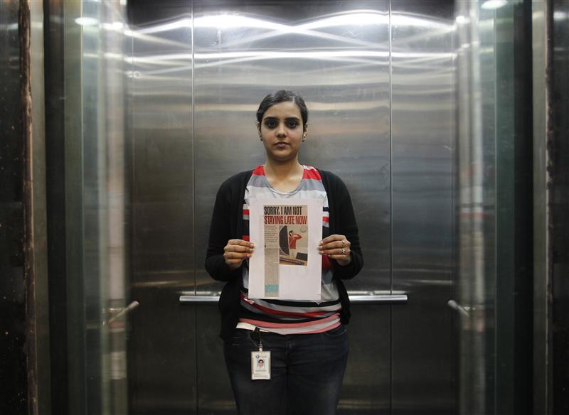 Deepshikha Bharadwaj, 24, who works for an advertising agency, poses inside her office elevator  in New Delhi