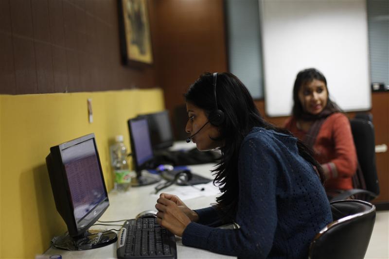 Sheetal, 23, who works at a night call centre, poses for a photograph in her office in New Delhi
