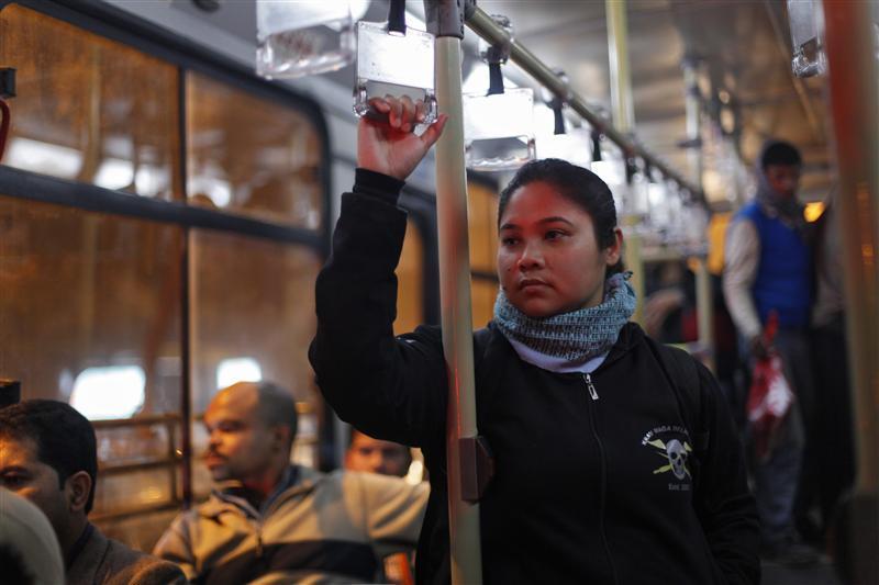 Baishali Chetia, 30, a freelance visual artist, travels on a bus after attending a Krav Maga class, an Israeli self defence technique, in New Delhi