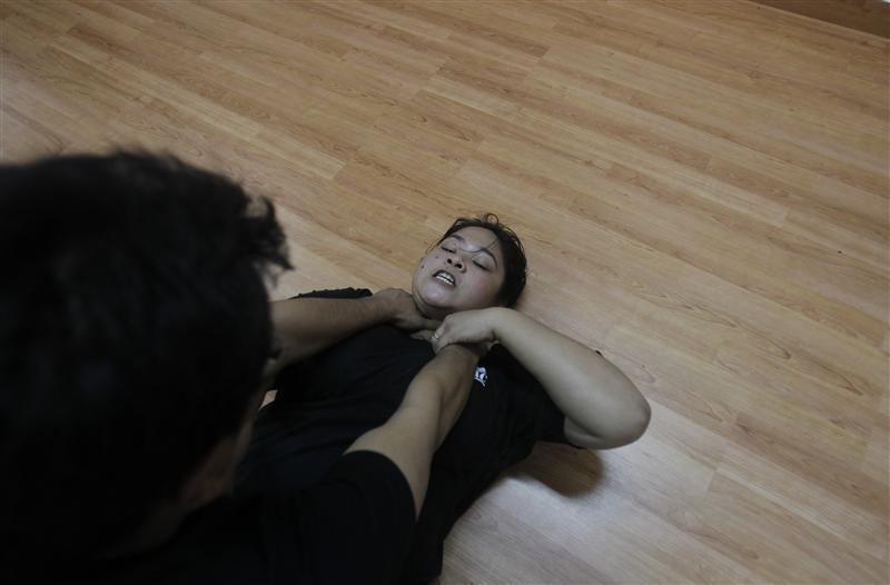 Baishali Chetia, 30, a freelance visual artist, takes part in a Krav Maga class, an Israeli self defence technique, in New Delhi