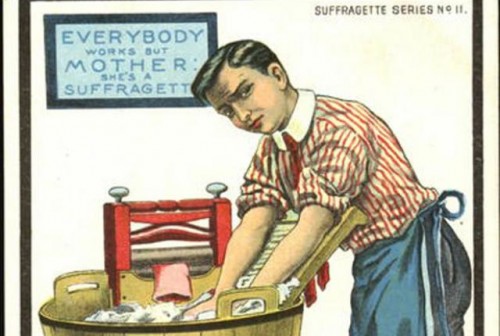 An anti-suffragette cartoon. A man washing laundry. On the wall, a board reads, "Everybody works but mother: she's a suffragette".