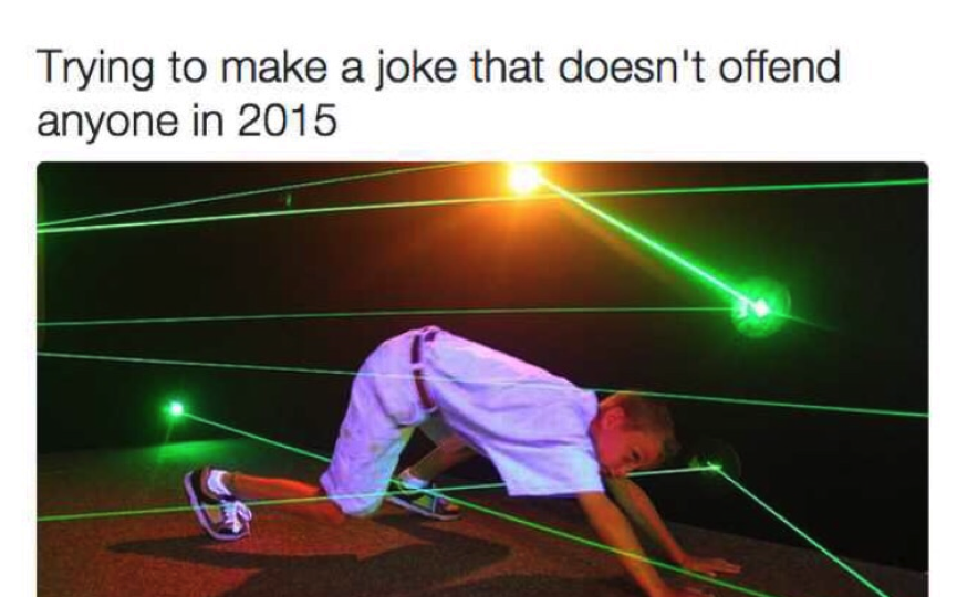 A school boy trying to move through several intersecting and haphazard green light rays without touching any. On top of the photo is written, "Trying to make a joke that doesn't offend anyone in 2015."