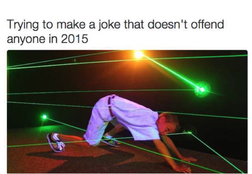 A school boy trying to move through several intersecting and haphazard green light rays without touching any. On top of the photo is written, "Trying to make a joke that doesn't offend anyone in 2015."