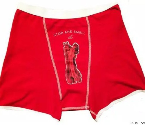 A man's red underwear. "Stop and smell the" written over a penis-shaped cutout in the centre.