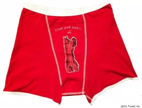 A man's red underwear. "Stop and smell the" written over a penis-shaped cutout in the centre.