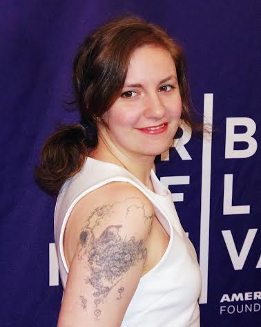 A woman in a white sleeveless tee shirt.