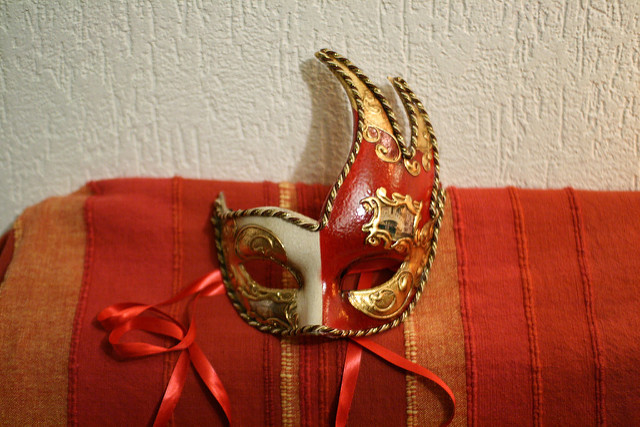 A red and white carnival eye mask.