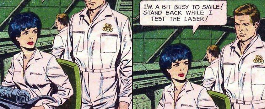 A two-panel comic. A man in white pants and tucked-in white shirt stands behind a woman who is wearing similar clothing. She looks to the side while working on some machine at the table. She says with a stern face to him, "I am a bit busy to smile. Stand back while I test the laser."