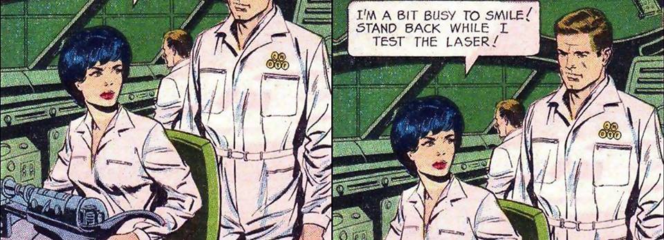 A two-panel comic. A man in white pants and tucked-in white shirt stands behind a woman who is wearing similar clothing. She looks to the side while working on some machine at the table. She says with a stern face to him, "I am a bit busy to smile. Stand back while I test the laser."