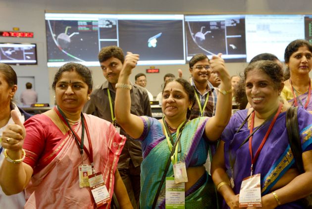 Women scientists at ISRO cheering over Mangalyaan’s success by giving a thumbs-up.