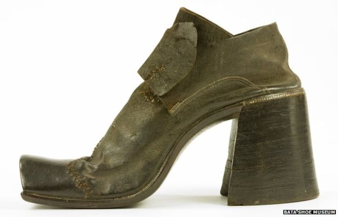 A brown leather shoe with thick, high heels. On the bottom right corner is written "BATA shoe museum".