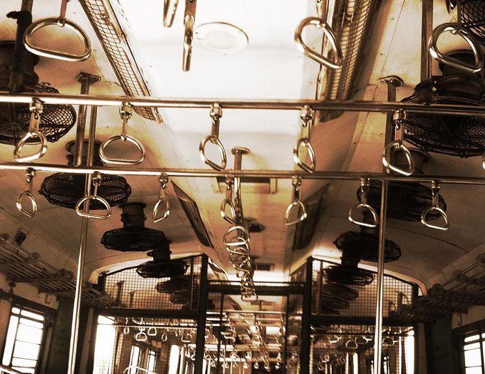 A shot of a ceiling of a bus, showing grab handles and fans attached to the ceiling. Screen reader support enabled. A shot of a ceiling of a bus, showing grab handles and fans attached to the ceiling.