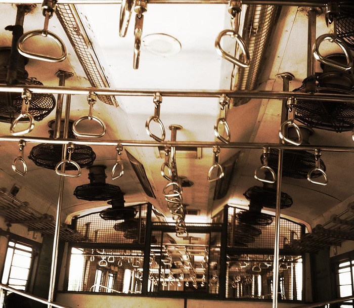 A shot of a ceiling of a bus, showing grab handles and fans attached to the ceiling. Screen reader support enabled. A shot of a ceiling of a bus, showing grab handles and fans attached to the ceiling.