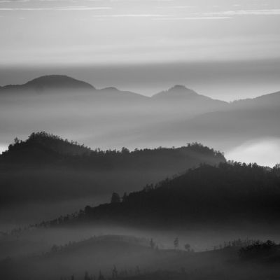 Black-and-white softened photo of a mountainous landcape.