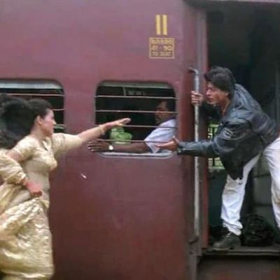 Still from DDLJ, Kajol running towards a running train while Shah Rukh Khan extenda a hand from the train