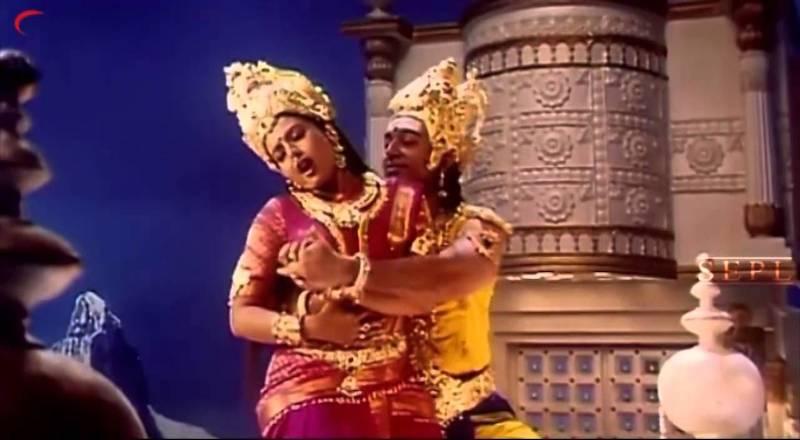 A photograph of Kaathala Kaathala , where the man wearing a heavily dressed head gearis trying to grope a woman from behond, while the woman is trying to get rid of his hold. She is also dressed in saree and a heavy head gear. Screen reader support enabled. A photograph of Kaathala Kaathala , where the man wearing a heavily dressed head gearis trying to grope a woman from behond, while the woman is trying to get rid of his hold. She is also dressed in saree and a heavy head gear.