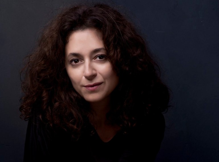 The image is a portrait of the author, Ece Temelkuran.