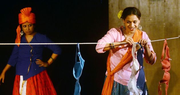 Theres are two photos which are stills from the play,Dohri Zindagi. In thr first photograph, there are two women,one is impersonating a man and the other woman is drying out her laundry (bras), she has a sunflower in her hair. In the second photograph the same women are holding eachother and facing eachother. The third photograph is a still of Vijaydan Detha from his documentary.