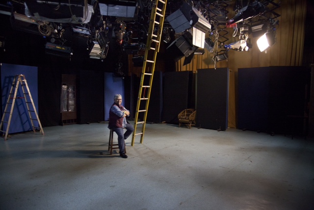 Shohini Ghosh at a film set. Lights, cameras, and reltaed instruments are hanging from the ceiling.