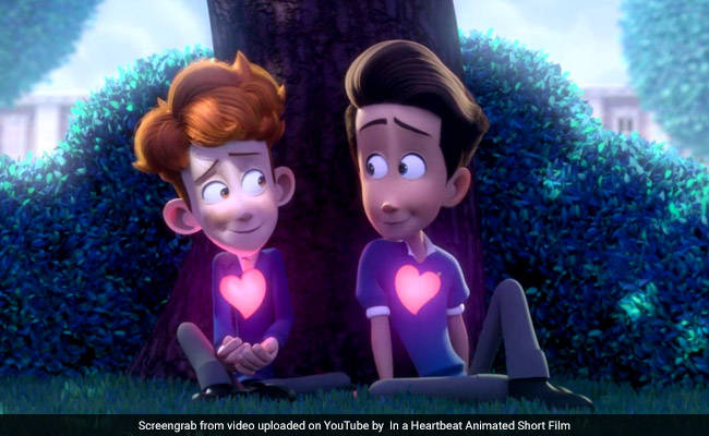 Still from an animated video with two small boys sitting by a tree, looking wide-eyed with love at each other.