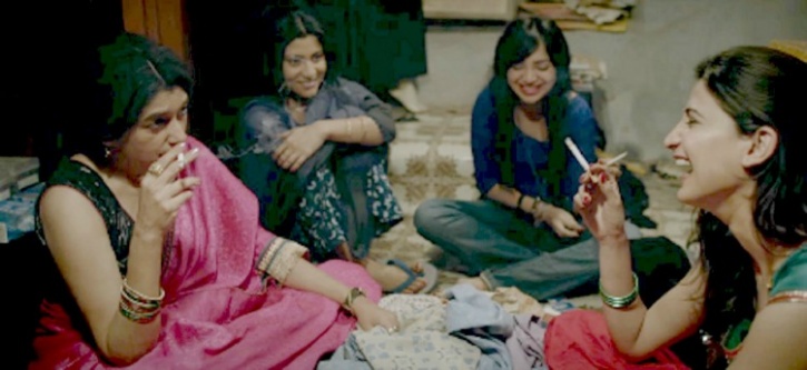 screenshot from the movie Lipstick under my Burkha. four women are sitting together, talking, laughing. two of them hold cigarettes.