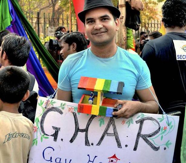 Photo of founder Sachin Jain, holding up a placard that says ‘G.H.A.R’