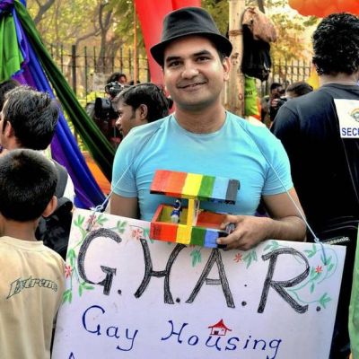 Photo of founder Sachin Jain, holding up a placard that says ‘G.H.A.R’