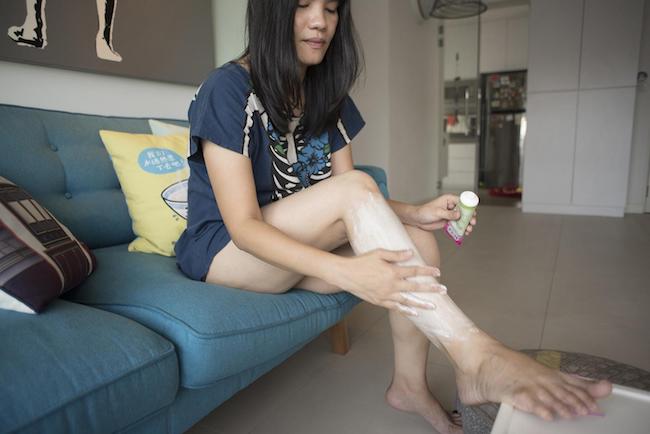 June at home, shaving her legs.
