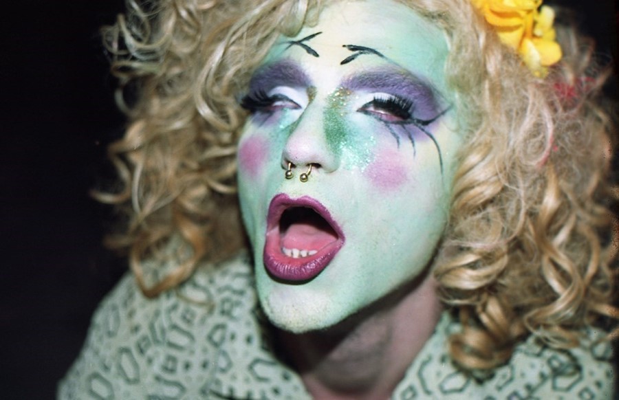 photo of a drag queen with white paint all over her face and blonde hair