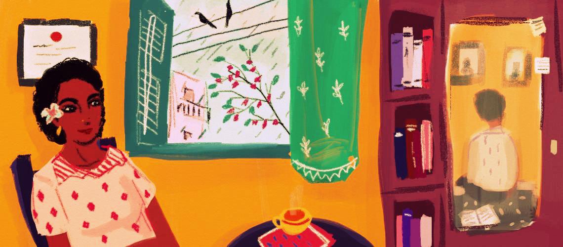 To the left of the image, a person with short dark hair with a flower in it sits in a chair, a small smile on their face and a coffee table in front of them. To the right, we see the reflection of a person’s back in a mirror on the door of a cupboard. The walls of the room are a warm yellow, and through a large open window we see birds, branches and a building. Credit: Upasana Agarwal.