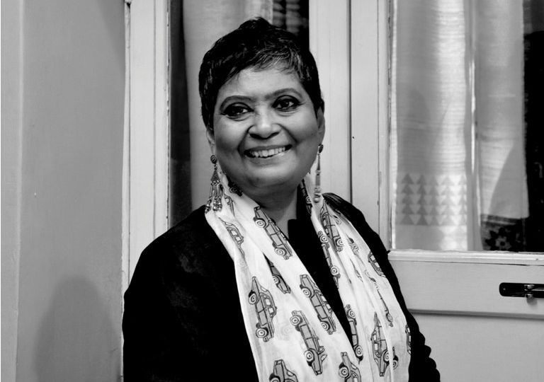 black and white picture of activist ratnaboli ray wearing a black kurta and white dupatta