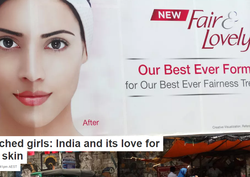 Picture of a woman on a billboard, half of her face is fair-complexion, the other half is dark-complexioned