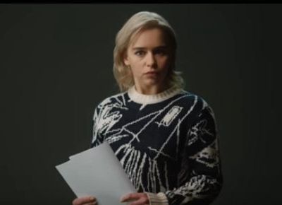 Picture of actress Emilia Clarke: she has short blonde hair and is wearing a black and white patterned top