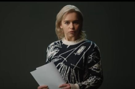 Picture of actress Emilia Clarke: she has short blonde hair and is wearing a black and white patterned top