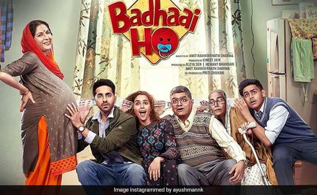 poster for the bollywood film, 'badhai ho', where four people are trying to listen to s pregnant woman's belly