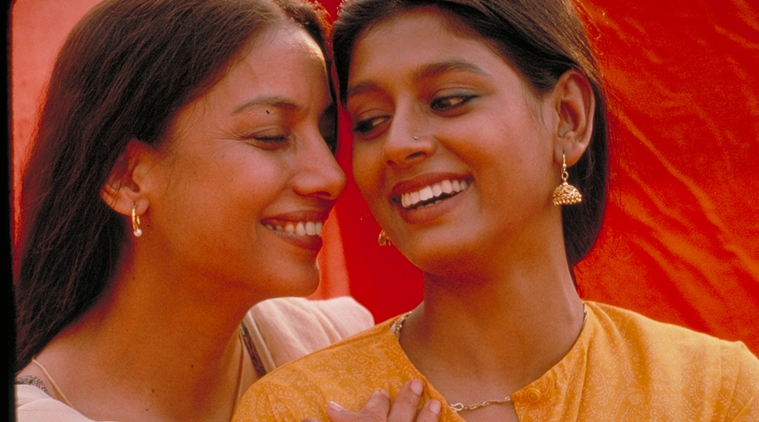 Still from "Fire", showing two women standing together intimately, smiles on their faces