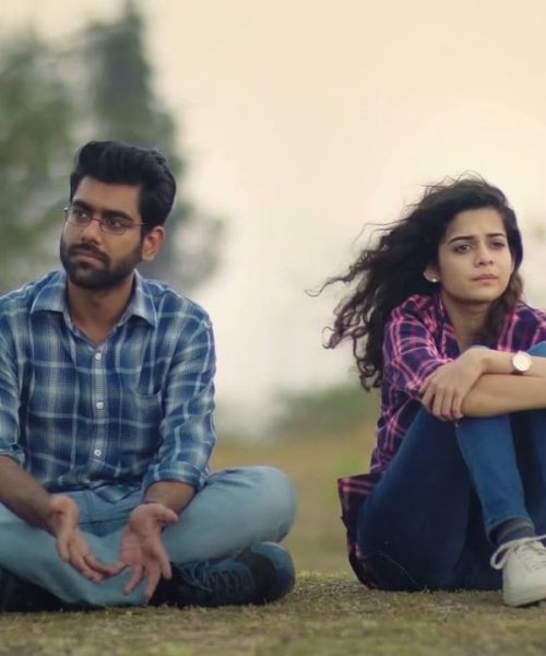 Still from Netflix's 'Little Things' : a man and woman sit beside each other in the grass