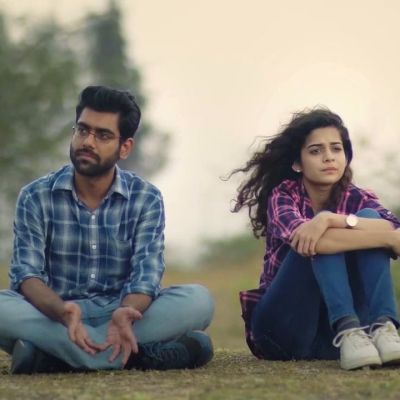 Still from Netflix's 'Little Things' : a man and woman sit beside each other in the grass