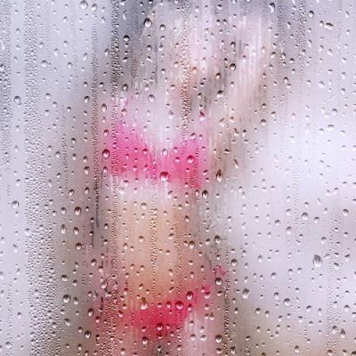 porn: a blurred image of a women clad in pink lingerie seen behind a fogged glass